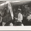 Barker at sideshow with performers, state fair, Donaldsonville, Louisiana