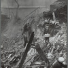 Men sifting through the rubble