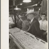 Man and woman looking at display of cheap jewelry, state fair, Donaldsonville, Louisiana