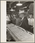 Man and woman looking at display of cheap jewelry, state fair, Donaldsonville, Louisiana