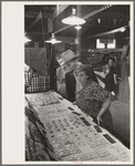 Man and woman looking at display of cheap jewelry, state fair, Donaldsonville, Louisiana