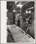 Man and woman looking at display of cheap jewelry, state fair, Donaldsonville, Louisiana