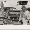 Couple sitting on bench, state fair, Donaldsonville, Louisiana