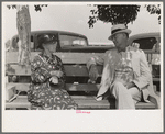 Couple sitting on bench, state fair, Donaldsonville, Louisiana