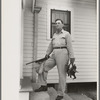 Joseph La Blanc, wealthy Cajun farmer, standing on steps of home with birds from a morning shooting, Crowley, Louisiana