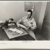 Joseph La Blanc at the desk in his office, reading morning mail, near Crowley, Louisiana