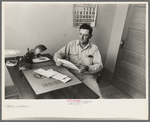 Joseph La Blanc at the desk in his office, reading morning mail, near Crowley, Louisiana
