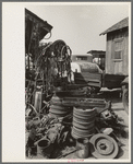 Fly wheels and speedometer cables in junkyard, Abbeville, Louisiana