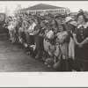 Crowd of people behind the rope watching ceremonies on the main platform, state fair, Donaldsonville, Louisiana