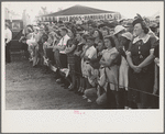 Crowd of people behind the rope watching ceremonies on the main platform, state fair, Donaldsonville, Louisiana