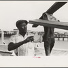 Negro stevedore handling lumber in unloading process, Pilottown, Louisiana, the "El Rito"