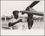 Negro stevedore handling lumber in unloading process, Pilottown, Louisiana, the "El Rito"