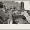 Negro stevedores handling drums, New Orleans, Louisiana