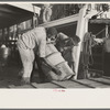 Negro stevedores handling drum, New Orleans, Louisiana