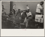 People sitting on dock, New Orleans, Louisiana