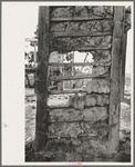 Detail of construction of old house; note the wooden cross lath. The construction material composed of mud and native moss. Near Edgard, Louisiana