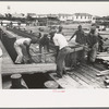 Negro stevedores loading stove on boat, Burrwood, Louisiana