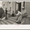 Men sitting on steps of post office, Lafayette, Louisiana
