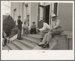 Men sitting on steps of post office, Lafayette, Louisiana