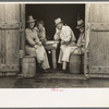 Group of men in a shack on the levee near Norco, Louisiana. They were taking refuge from the rain