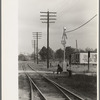 Men sitting on signal tower beside railroad track, Morgan City, Louisiana