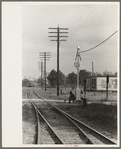 Men sitting on signal tower beside railroad track, Morgan City, Louisiana