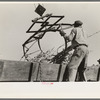 Manipulating scissors crane used for loading sugarcane in field near New Iberia, Louisiana