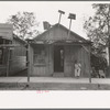 Man sitting in front of small store, Opelousas, Louisiana