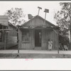 Man sitting in front of small store, Opelousas, Louisiana