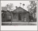 Man sitting in front of small store, Opelousas, Louisiana