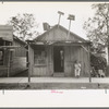 Man sitting in front of small store, Opelousas, Louisiana