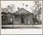 Man sitting in front of small store, Opelousas, Louisiana