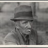 Migrant worker resting along roadside, Hancock County, Mississippi