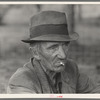 Migrant worker resting along roadside, Hancock County, Mississippi