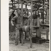 Cut-over farmer near Amite, Louisiana, drawing water from well