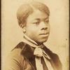 Portrait of young woman with velvet lapels and ribbon bow around neck