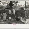 Negro family praying at graves of their relatives on All Saints' Day, New Roads, Louisiana