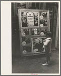 Little boy looking at movie display, New Iberia, Louisiana