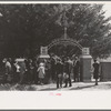 On All Saints' Day at New Roads, Louisiana Negroes assembeled in the church for preliminary ceremonies and then marched en masse to the cemetery for ceremonies there. Part of the group is shown entering the cemetery