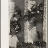 Decorations on side of family burial vault in cemetery at New Roads, Louisiana on All Saints' Day