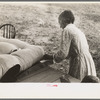 Wife of small cane farmer near Jarreau, Louisiana, making mattress of moss