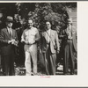 Allen Ramsey Wurtele, second from left, inventor of mechanical sugarcane harvester with sugarcane experts who came up from General International Convention to see his harvester. Mix, Louisiana