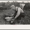 Day laborer working around his shack near New Iberia, Louisiana