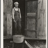 Day laborer standing in doorway of his home in sugarcane fields, near New Iberia, Louisiana