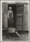 Day laborer standing in doorway of his home in sugarcane fields, near New Iberia, Louisiana