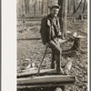 Farmer of Chicot Farms, Arkansas resting after chopping wood