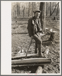 Farmer of Chicot Farms, Arkansas resting after chopping wood