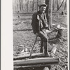 Farmer of Chicot Farms, Arkansas resting after chopping wood