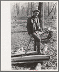 Farmer of Chicot Farms, Arkansas resting after chopping wood