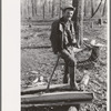 Farmer of Chicot Farms, Arkansas resting after chopping wood